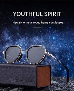 Macro shot of gold and black oval sunglasses with gear texture on textured leather case
