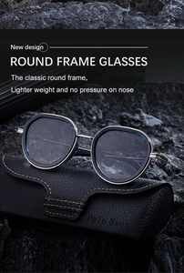 Detail of oval sunglasses with metal temples and a leather case on a rock background