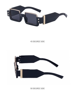 Close-up of square black sunglasses with gold metal trim and rivets from side angles