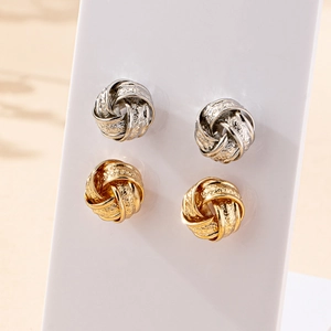Elegant twisted knot earrings set in gold and silver finish with vintage matte texture