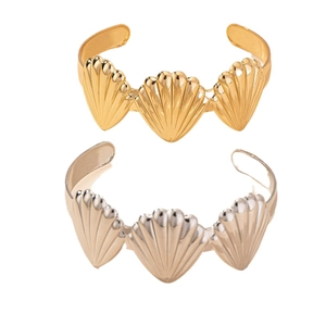 Elegant gold and silver open bracelets featuring seashell designs with polished texture