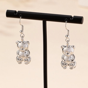 Polished silver bear earrings with 3D sitting design on black display stand