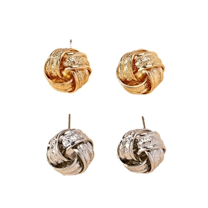 Elegant gold and silver twisted knot stud earrings with vintage metallic textured finish