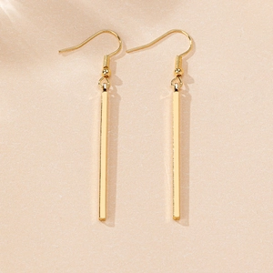 Detailed view of long gold rectangular bar drop earrings with sleek fishhook design