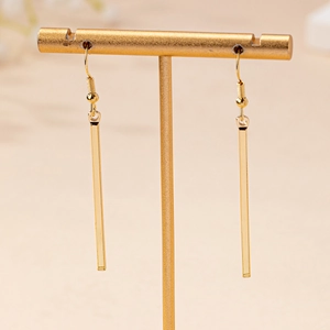 Elegant gold-tone geometric rectangular drop earrings on a professional jewelry stand
