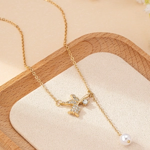 Elegant gold Y-shaped swallow necklace with pave crystals and a hanging pearl pendant