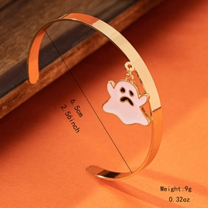 Detailed view of 6.5cm gold cuff bracelet featuring a cute white enamel ghost charm