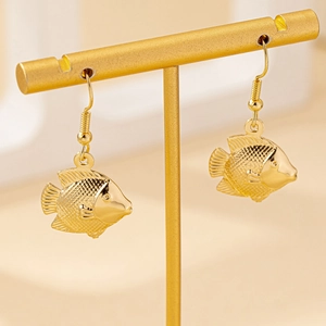 Elegant gold fish drop earrings with detailed scale texture on a golden T-stand