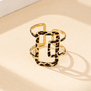 Detailed view of wide leopard print hollow geometric ring with golden frame design