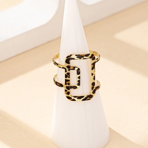 Fashionable leopard print hollow geometric gold ring displayed on white cone stand