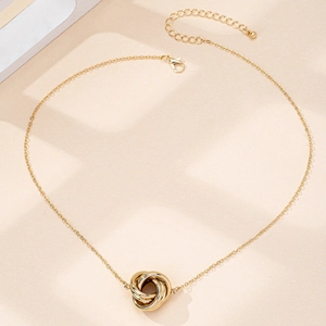 Close-up of interlocking twist pendant with lobster clasp and adjustable necklace chain