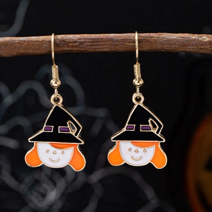 Halloween witch earrings with black hats and orange hair hanging on a wooden branch