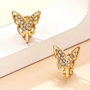 Elegant gold butterfly ear clips with clear rhinestones on white minimalist backdrop