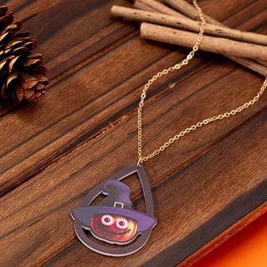Halloween pumpkin necklace with purple witch hat pendant on rustic wood background
