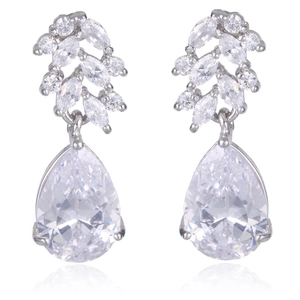 Macro view of silver tassel earrings with teardrop cubic zirconia and leaf patterns