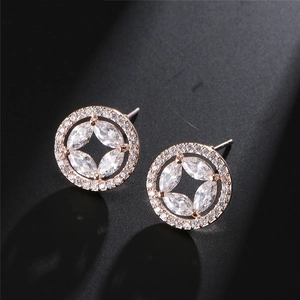 Macro view of rose gold round stud earrings with marquise-cut star pattern crystals