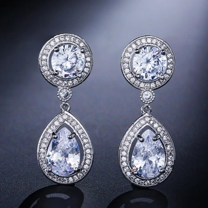 Detail of silver tassel earrings featuring teardrop zircon pendants and micro-pave setting