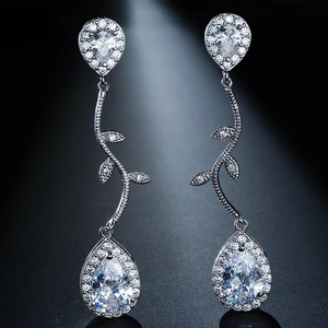 Close-up of silver tassel earrings featuring sparkling pear-cut cubic zirconia stones