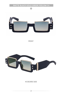 Detail of matte black square sunglasses with gold metal accents and green-yellow lenses