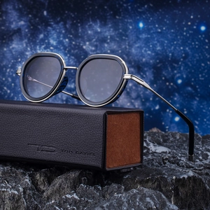 Retro punk oval sunglasses with metallic silver temples on leather case and star background