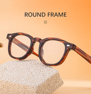 Detailed close-up of retro round tortoiseshell eyeglass frames with metal diamond rivets