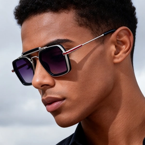 Detail of square double-bridge sunglasses featuring red stripe accents on metal temples