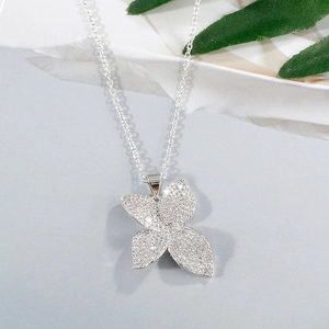 Silver four-leaf clover pendant necklace with sparkling white pavé crystals on chain