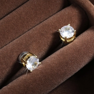 Elegant gold-plated stud earrings with four-prong round cubic zirconia in a jewelry box