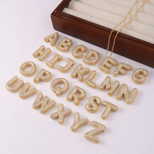 Golden bubble letter pendants A-Z with zircon pavé setting on a fine chain necklace