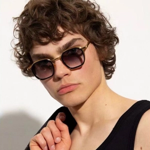 Close-up of golden square metal sunglasses with purple gradient lenses on male model