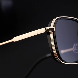 Macro detail of golden metal temples and black frame on stylish square sunglasses