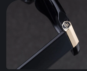 Macro shot of durable metal hinge with logo detail on black double-bridge sunglasses
