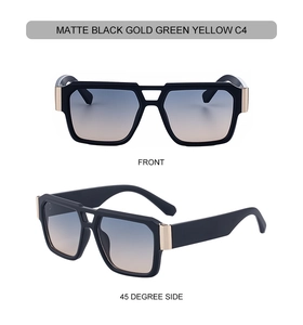 Detail of matte black sunglasses with gold metal accents and green-yellow gradient lenses