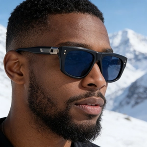 Men's oversized black cat-eye polarized sunglasses with blue lenses in a snowy mountain set