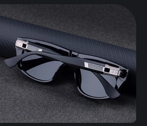 Detailed view of black frame sunglasses with elegant silver metallic stripe accents