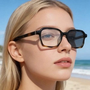 Chic photochromic square sunglasses with tortoise frame shown in a sunny beach setting