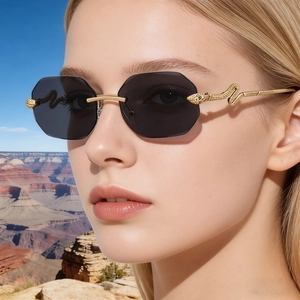 Close-up of rimless square sunglasses with gold snake-shaped metal temples on a model