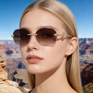 Close-up of frameless square sunglasses with gradient lenses and golden snake temples