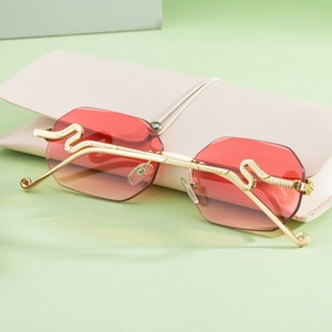 Detail of gold snake-embossed temples on rimless gradient red polygon sunglasses