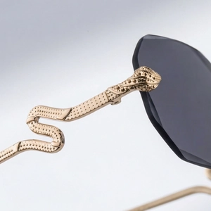 Detailed close-up of golden snake-shaped metal temples on rimless square sunglasses