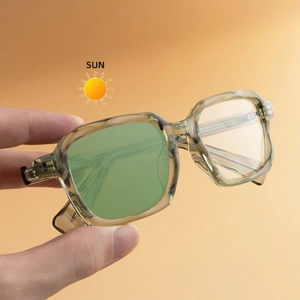 Women's square photochromic sunglasses with transparent olive green frames in the sun