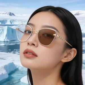 Detail of cat-eye sunglasses with rhinestone-encrusted gold metal frames and photochromic lenses