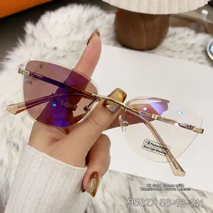 Detail of rimless photochromic sunglasses with golden metal temples and anti-blue lenses