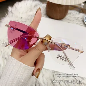 Detail of cat-eye photochromic lenses changing from clear to pink in gold metal frame