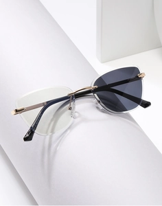 Detail of rimless cat-eye sunglasses with gradient lenses and metallic spring hinges