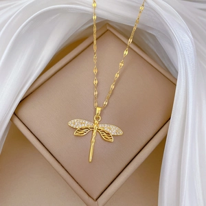 Elegant gold dragonfly necklace with sparkling zircon wings on a premium jewelry box