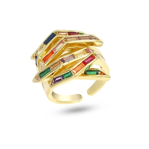Detail of multilayer golden ring featuring baguette-cut colorful gemstones and open band