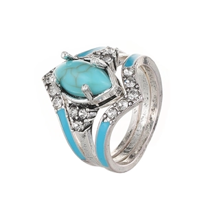 Detail of vintage turquoise ring set with marquise stone and blue enamel accents
