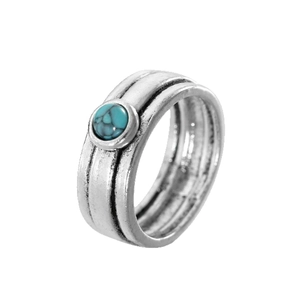 Retro silver ring with turquoise stone inlay and vintage textured patterns on white background