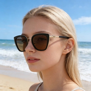 Fashionable cat-eye polarized sunglasses for women with gold metal trim and brown lenses